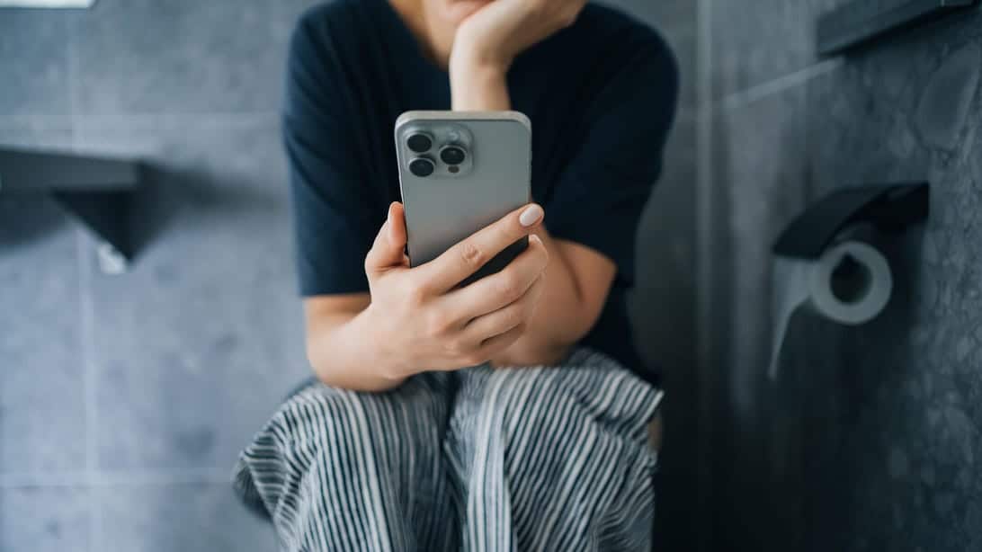 Checking Your Phone in the Bathroom Might Be Doing More Harm Than You Think 1 gettyimages 2204131072 zOhlhs