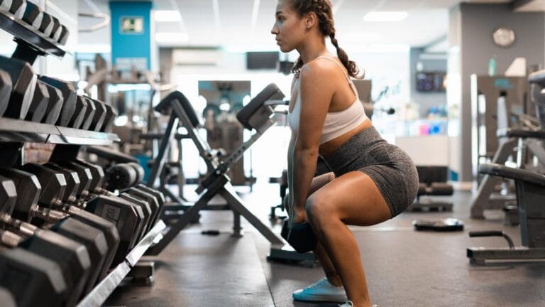 person doing squat at gym 0rgcyE