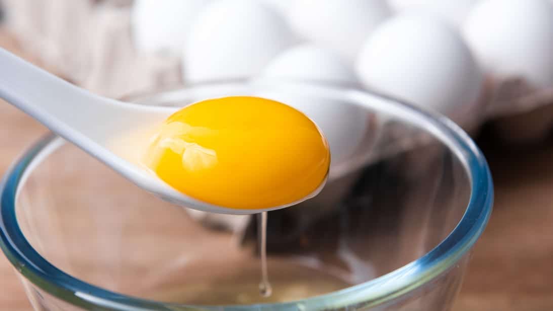 Not Getting Enough Sunlight? These 11 Foods Are Rich in Vitamin D 1 spoon holding egg yolk