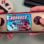 AYANEO Pocket Micro Classic Advance Wars in hand scaled