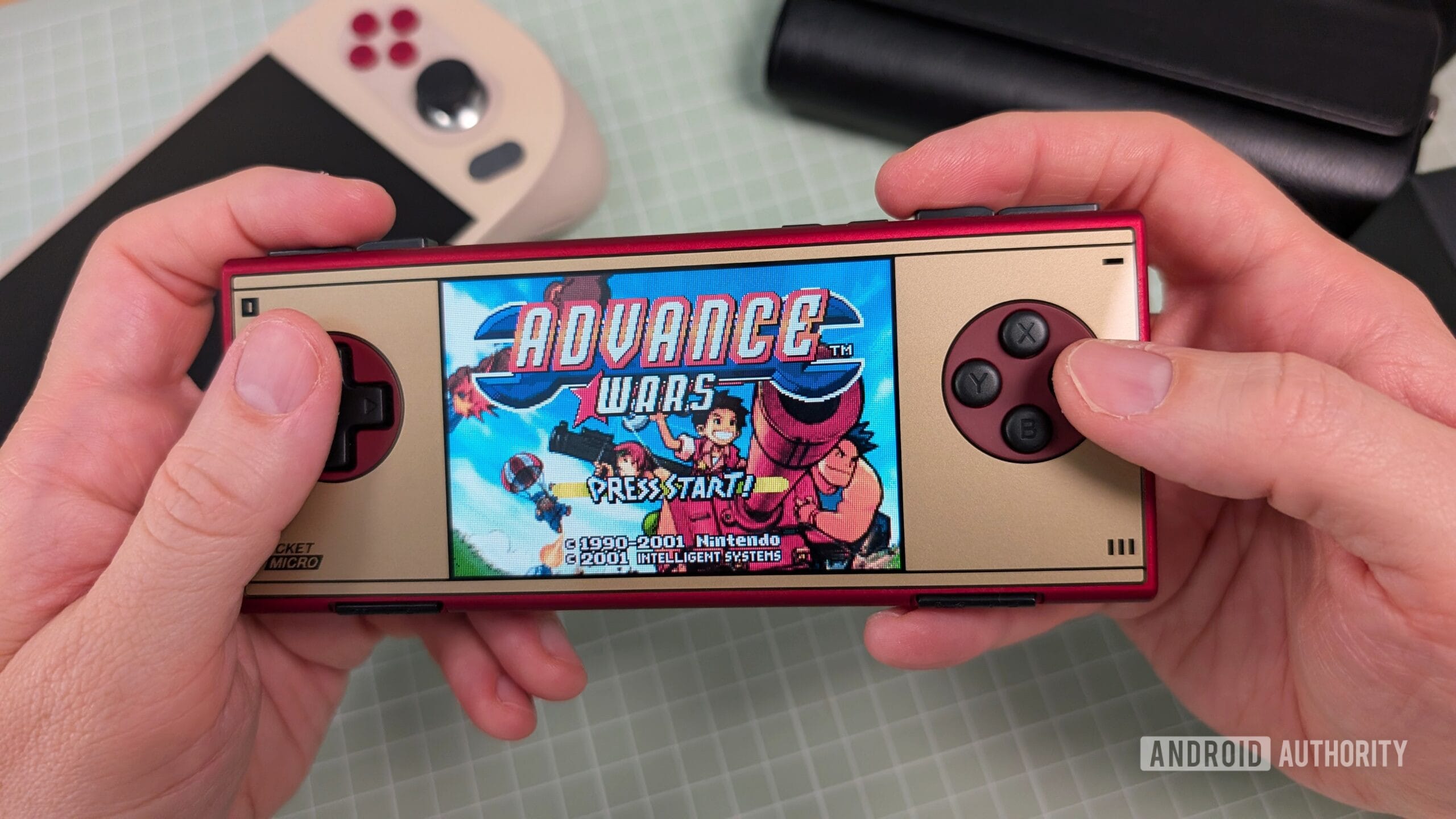 AYANEO Pocket Micro Classic Advance Wars in hand scaled